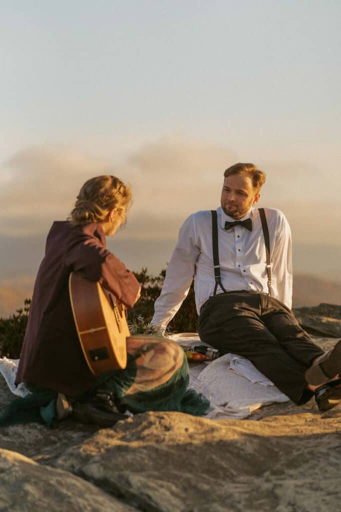 newly weds sitting on mountain having a picnic after they elope in north carolina