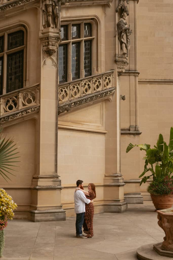 couple standing in front of the Biltmore for their engagement photos
