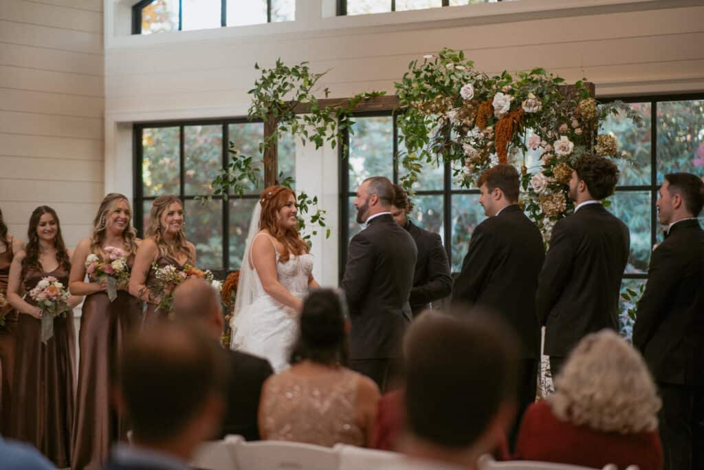bride and groom holding hands at Asheville wedding venue altar