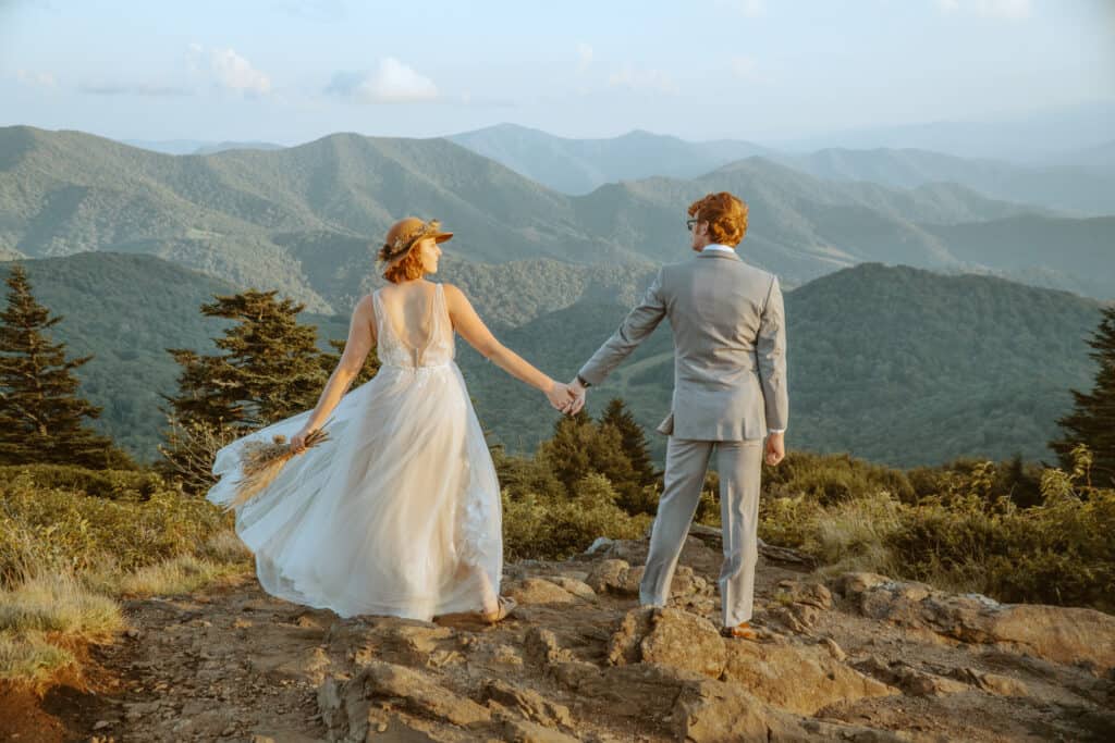 wedding couple holding hands on roan mountain asheville elopement