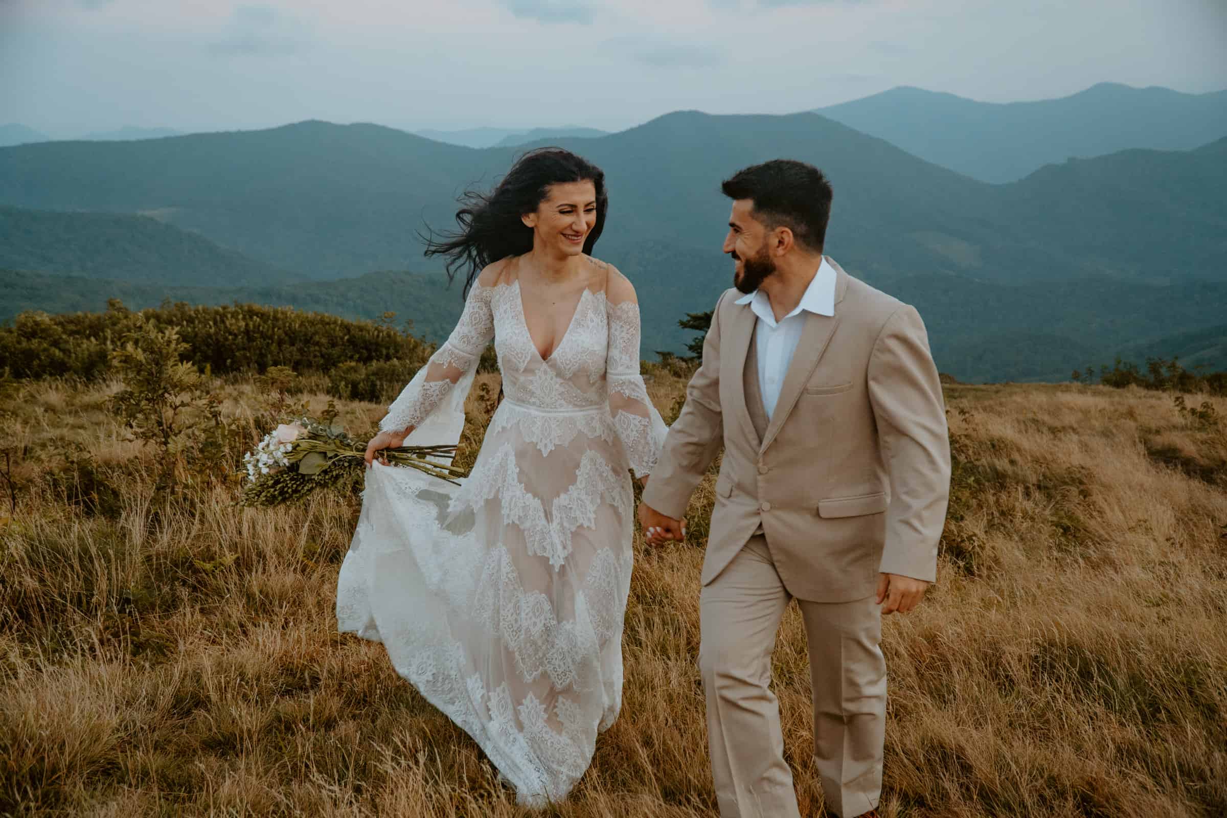 couple walking on mountain after they elope in asheville