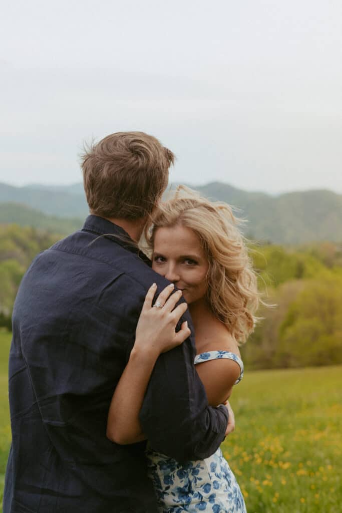 asheville engagement photos in field with mountain backdrop