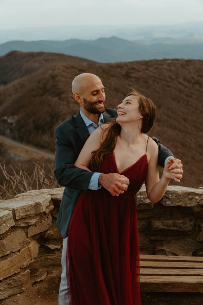 couple posing on mountain for asheville engagement photos