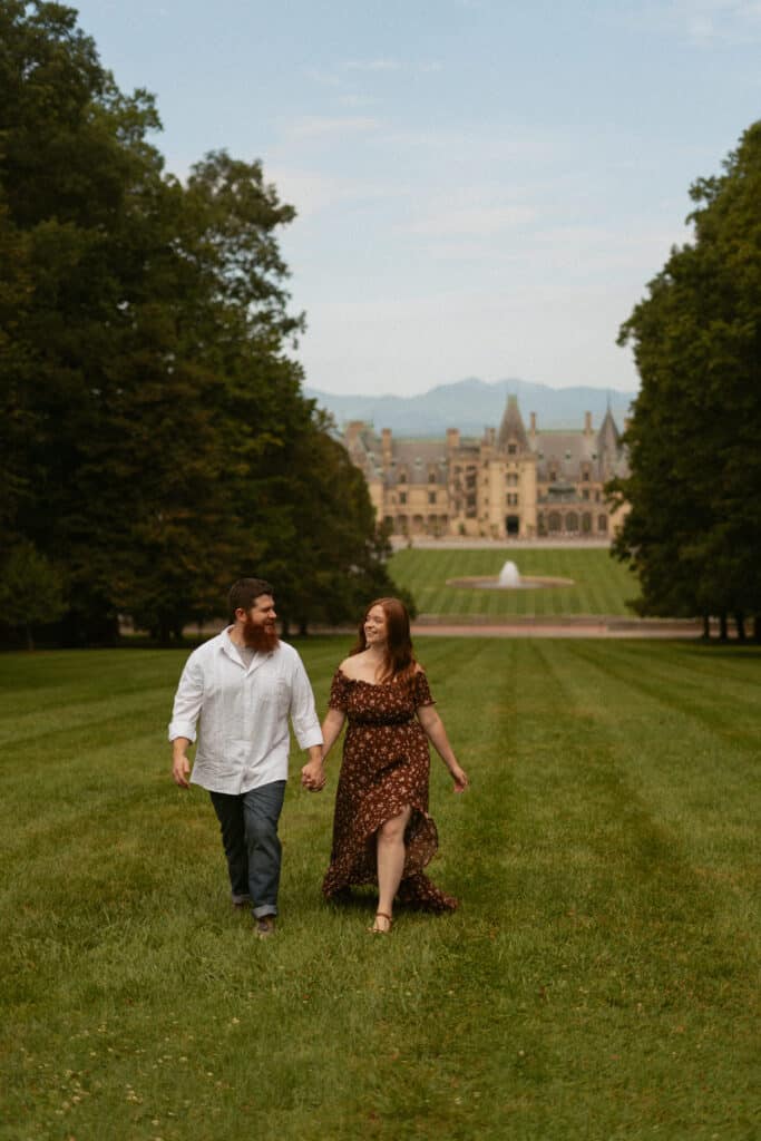 couple running on lawn of the Biltmore