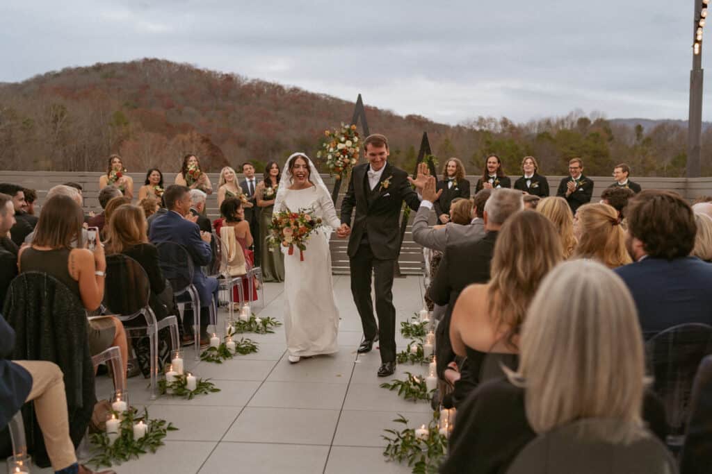 bride and groom holding hands walking at their asheville wedding venue
